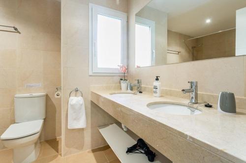 薩拉皮塔的住宿－Wohnanlage mit mehreren Apartments und Poolbereich，一间带水槽、卫生间和镜子的浴室