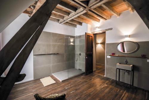 a attic bathroom with a shower and a sink at Chateau de Saint Dau in Figeac