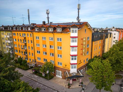 a group of yellow buildings on a city street at Park Hotel Laim in Munich