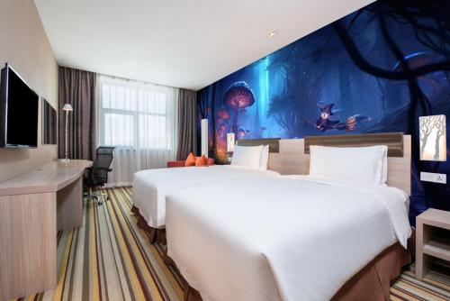 a hotel room with a large bed and a mural at Wanda Momoland Changbaishan in Fusong