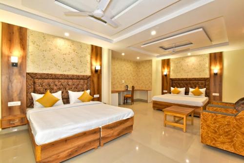 a large bedroom with two beds and a table at Hill Pine View in Dharamshala
