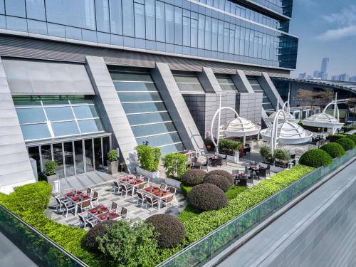 a view of a building with tables and chairs at Langham Place Guangzhou - Walking distance to Canton Fair in Guangzhou