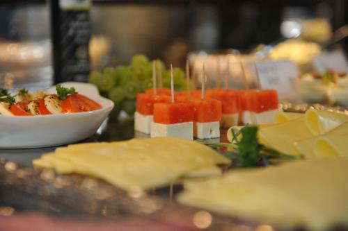 a plate of food with fruit and cheese on a table at Vareler Brauhaus-Hotel Varel Dangast in Varel