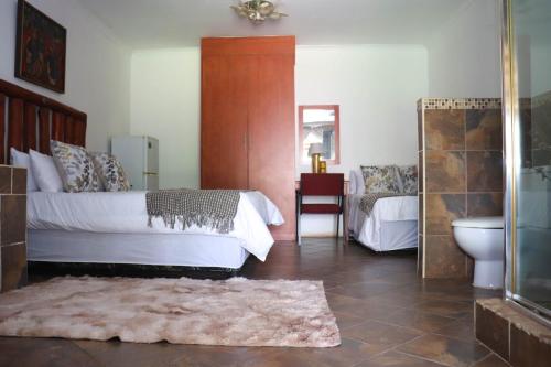 a bedroom with a bed and a sink and a mirror at Umnotho We Afrika House in Erasmus