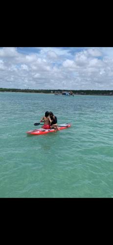 a couple of people on a kayak in the water at Barco do Amor in João Pessoa