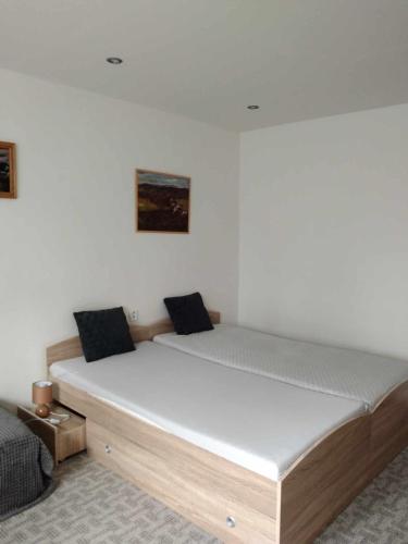a bed in a room with a white mattress at Ubytování ve Frýdku in Frýdek-Místek