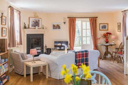 a living room with a couch and a fireplace at The Old Schoolroom by Bloom Stays in Canterbury