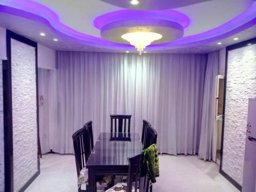 a dining room with a table and a purple ceiling at مساكن شيراتون المطار in Cairo