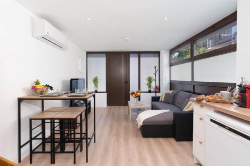 a kitchen and living room with a couch and a table at Le Val By ApiRent #Duplex #Climatisation in Le Cannet