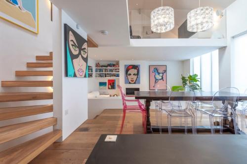 a dining room and living room with a table and chairs at Chic 2-bedroom home - Richmond upon Thames in London