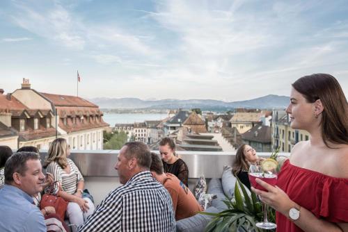 a group of people sitting on the roof of a building at Base Nyon in Nyon