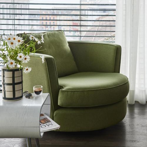 a green chair in a living room with a table at Base Nyon in Nyon