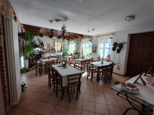 a dining room with tables and chairs in a house at Al Calar Della Sera in Sommariva del Bosco