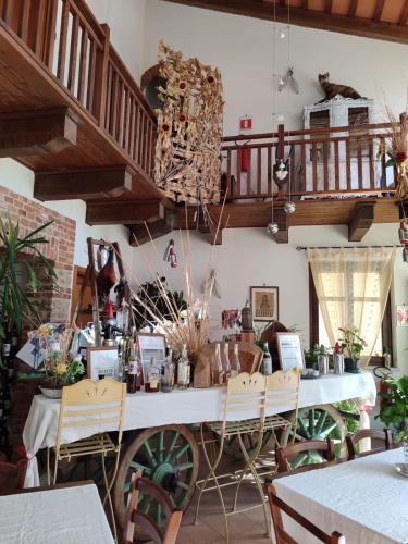 a room with a table with chairs and a staircase at Al Calar Della Sera in Sommariva del Bosco