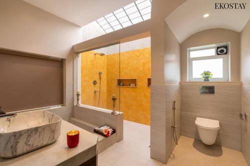 a bathroom with a tub and a shower and a sink at EKOSTAY Luxe - CASABLANCA VILLA in Igatpuri