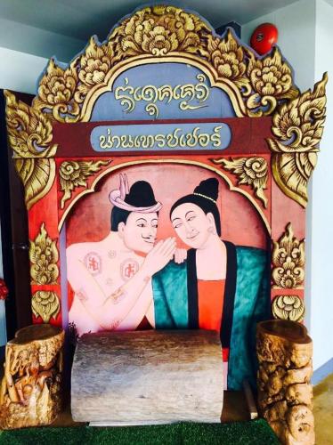 a cake with a picture of a man and a woman at Nan Treasure Hotel in Nan