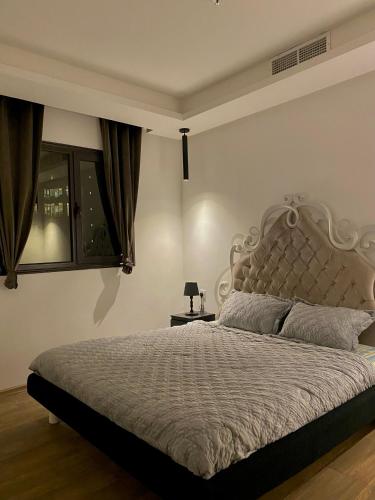 a bedroom with a large bed and a window at كويت in Kuwait