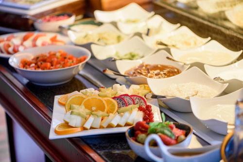 a buffet filled with different types of food on plates at Residenz Hotel Leipzig in Leipzig