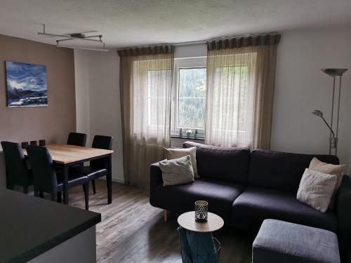 a living room with a couch and a table at Tgèsa Dutg Grond in Sedrun