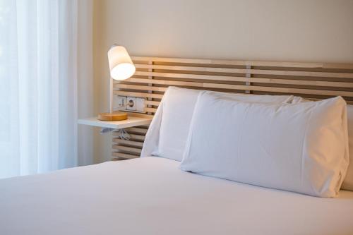 A bed or beds in a room at MAREA Hotel