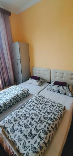 two beds sitting in a room with at Guesthouse Qeti in Batumi