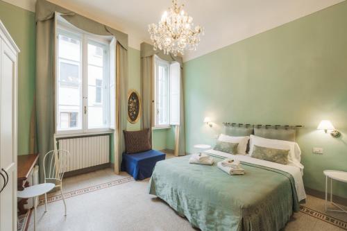 a bedroom with a large bed and a chandelier at B&Beatrice in Florence