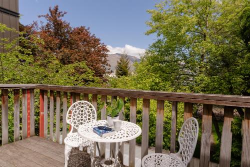 a table and two chairs on a deck at Haka Lodge Queenstown in Queenstown