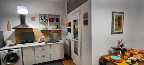 a kitchen with a sink and a washing machine at Alloggio turistico Politeama in Trieste