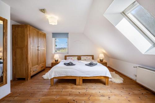 a attic bedroom with a bed and a window at Voßberg Fewo 2 in Grömitz