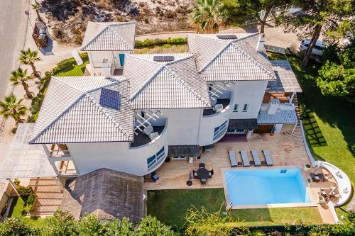 an aerial view of a house with a swimming pool at Kochab Comporta in Comporta
