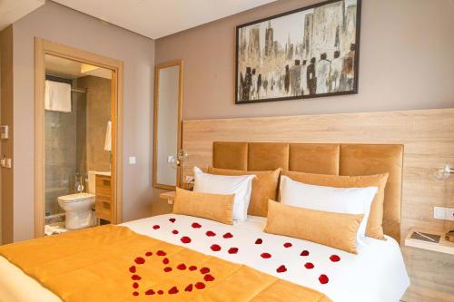 a bedroom with a bed with red hearts on it at Rent-inn Boutique Hotel in Rabat