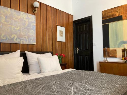um quarto com uma cama com almofadas brancas em Medusa house em Esztergom