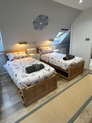 two twin beds in a room with at Ty Odyn. Best of Both Worlds. Rural yet Connected. in Newport