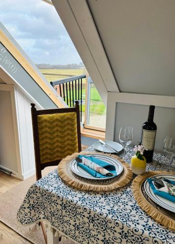 a dining room table with a blue and white table cloth at Ty Odyn. Best of Both Worlds. Rural yet Connected. in Newport