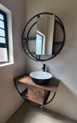 a bathroom with a sink and a mirror on the wall at Rosendal Kruger View Villa in Marloth Park