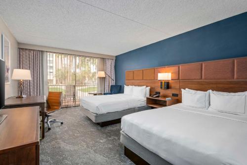 a hotel room with two beds and a large window at DoubleTree by Hilton Tucson-Reid Park in Tucson