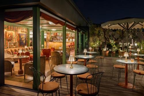 a restaurant with tables and chairs on a deck at La Fantaisie in Paris