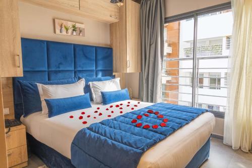 a blue bedroom with a large bed with a blue headboard at Rent-inn Boutique Hotel in Rabat