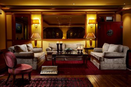 a living room with two couches and a table at Rodos Park in Rhodes Town