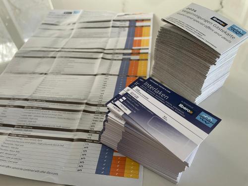 a pile of papers sitting on top of a table at Bellevue Apartment in Ringgenberg