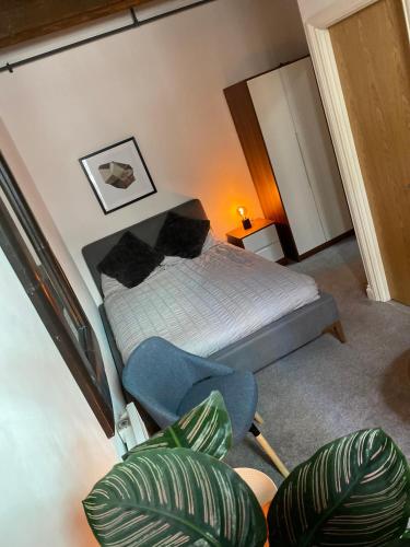a bedroom with a bed and a chair at WE-stay in Manchester