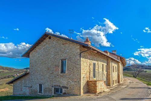 an old brick building on the side of a road at Serra Alta Langa Holiday Home in Trezzo Tinella