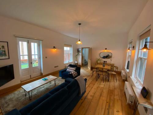 a living room with a couch and a table at Spacious Norwich Lanes Apartment with Roof Terrace in Norwich
