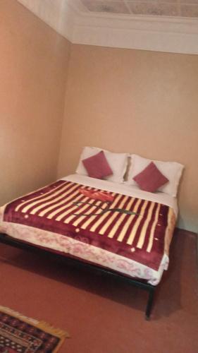 a bed with two pillows on it in a room at Gite d'étape nomade in Tajda