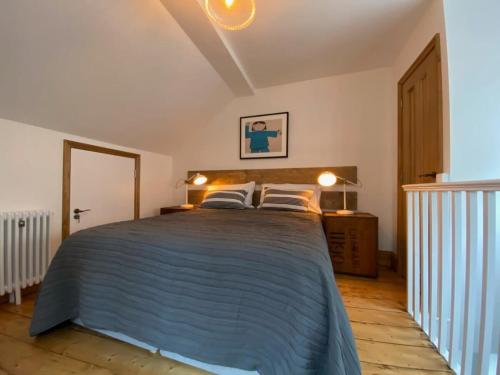 a bedroom with a large bed with two pillows at Spacious Norwich Lanes Apartment with Roof Terrace in Norwich