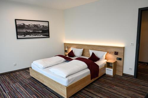 a bedroom with a large bed in a room at Soloplan City Resort in Kempten