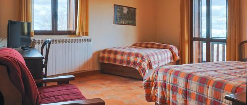 a hotel room with two beds and a tv at Park Hotel Bellavista in Gambarie dʼAspromonte