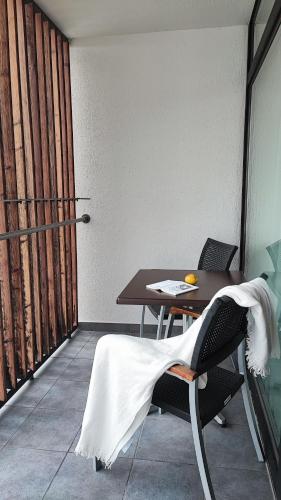 a room with a table and a chair with a towel on it at ...mein Graml in Bad Füssing