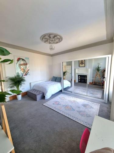 a bedroom with a bed and a mirror at Entire Apartment by City Centre & Harbourside in Bristol