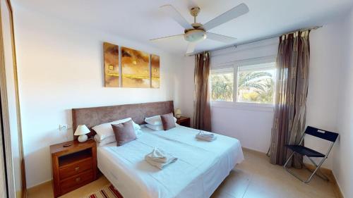 a bedroom with a bed with a ceiling fan and a window at Casa Espliego PJ-Murcia Holiday Rentals Property in Torre-Pacheco